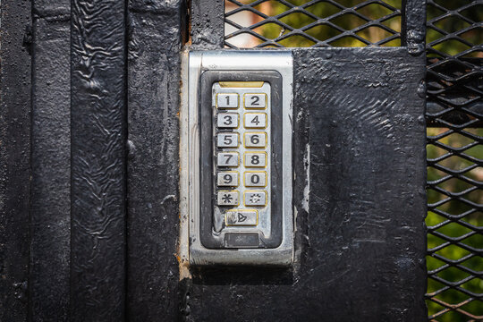 numeric keypad on concrete wall