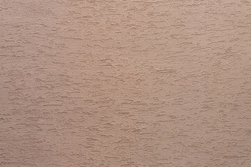 Background from a  pattern of beige  stone wall covered with decorative plaster.