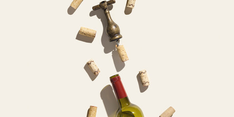 Background with wine corks, old corkscrew, wine bottle  on beige pastel color with shadow at sunlight, copy space. Wide banner with natural wooden bottle cap, metal vintage opener, copyspace