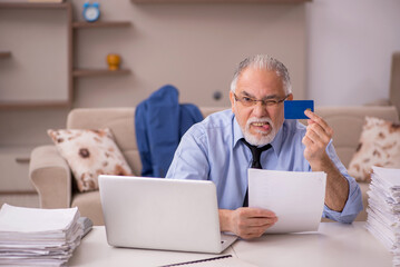 Fototapeta premium Old male boss working from home during pandemic