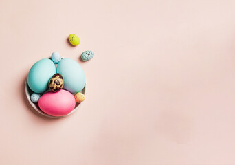 easter greeting card concept. set of varios pastel colorful egss on ceramic bowl on pink backround. Easter background. flatlay with copyspace