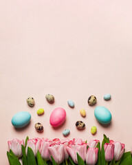 easter greeting card concept. bouquet of pink tulips with set of varios pastel colorful easter egss on pink backround. Easter background. top view with copyspace