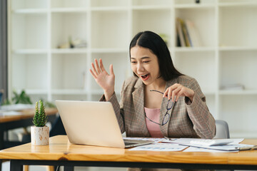 Excited asian woman sit at desk feel euphoric win online lottery, Asian happy overjoyed get mail at...