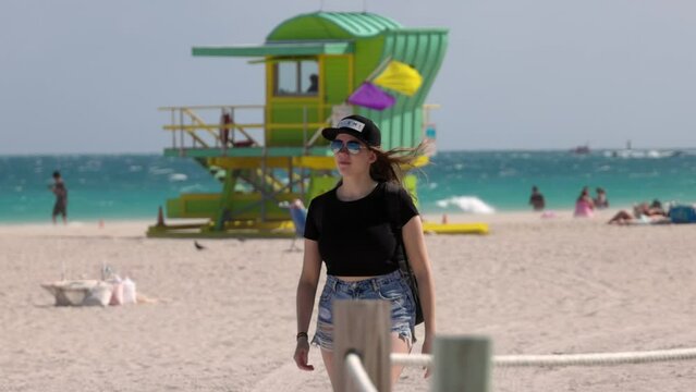 Pretty woman walks along Miami Beach on a sunny day - travel photography