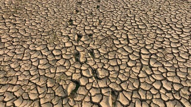 Foot print of people walking on dry cracked earth, Looking for fresh water on Dry land in dessert or In Lack of water Area. Climate change, Drought and water crisis.