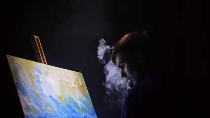 Artist copyist paint seascape with ship in ocean. Vaper smoke vape e-cigarette. Craftsman decorator draw as boat sail on blue sea with acrylic oil color. Draw finger, brush, knife palette. Indoor.