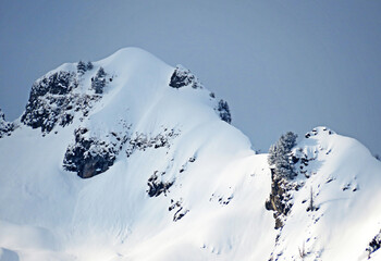 Fototapeta na wymiar Snow-capped alpine peak Schwarzchopf (1949 m) in Alpstein mountain range and in Appenzell Alps massif, Unterwasser - Canton of St. Gallen, Switzerland (Schweiz)