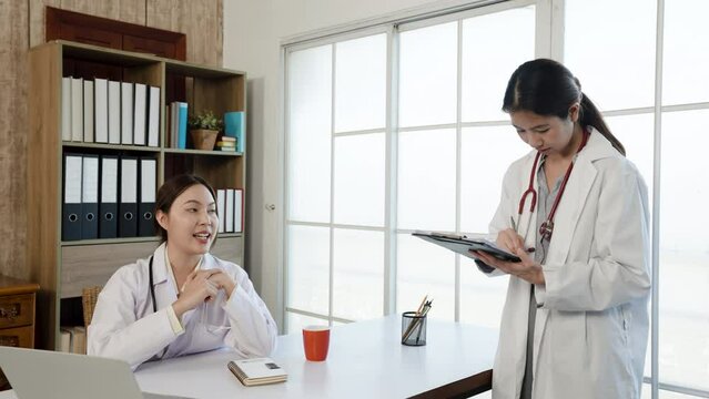 4K 50fps, Asian female medical student wearing a white shirt  ask for advice. about the sickness of the patient and the doctor's teacher in the office of the hospital