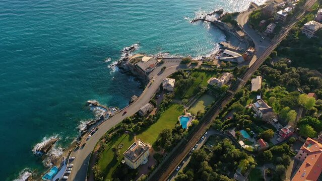 Aerial view over a coastal road, in sunny east Genova,, Italy - tilt, drone shot
