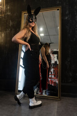young beautiful woman in a leather hare mask and with a whip, bdsm, fetish