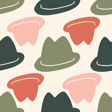 Vintage hats in different colours on sandy background.