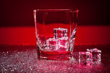 Glass transparent glass with ice cubes for cooling drinks.