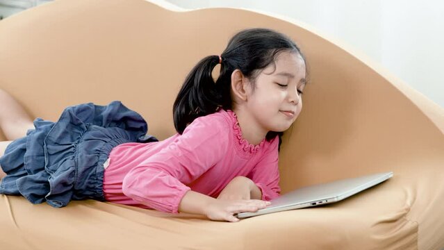 4K 50fps, An adorable Asian girl with two hair tied up, studying online on a laptop computer, then she shuts down her laptop in boredom and laziness.