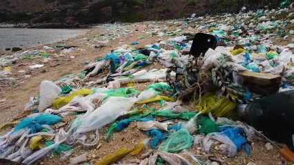 Plastic bags and marine debris littering sandy beach in Vietnam; drone