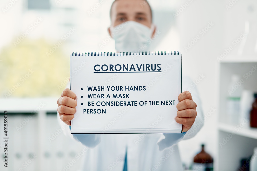 Poster Do your bit to evade the virus. Shot of a scientist holding a sign with a list of COVID-19 prevention measures on it in a laboratory.