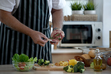 Senior caucasian chef with seasoning raw beef steak, senior man explains about meat steak in hand