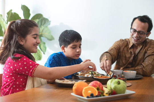 Happy Indian Family Enjoy With Indian Food, Having Family Dinner