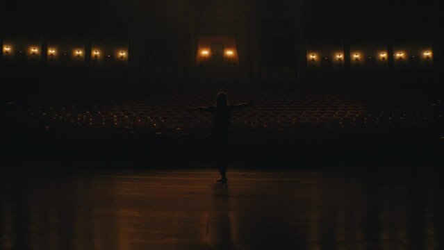 Dancer enjoy ballerina motion in light jumping. Beautiful woman ballerina perform ballet in white leotard close up dancer opera train flexibility body 4K. Pretty female ballet girl stage theater turn.