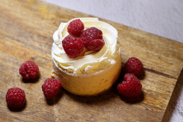 cheesecake with raspberries on wood table