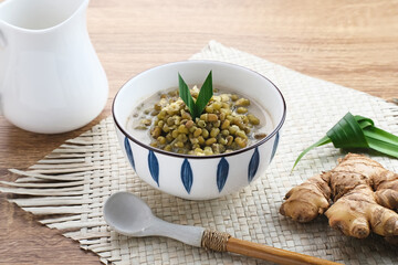 Mung Bean Porridge or Bubur Kacang Hijau, Indonesian dessert porridge of mung beans with coconut milk, pandan leaf and ginger. Served in bowl.
