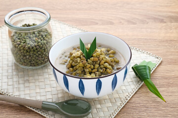 Mung Bean Porridge or Bubur Kacang Hijau, Indonesian dessert porridge of mung beans with coconut milk, pandan leaf and ginger. Served in bowl.
