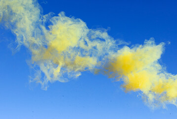 Fototapeta na wymiar Yellow smoke on a blue background.