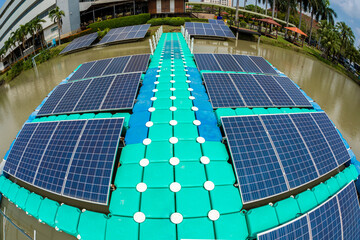 Platform of Plastic Floating Solar Cells, Panels on the water against blue sky inside public park in the city centre.