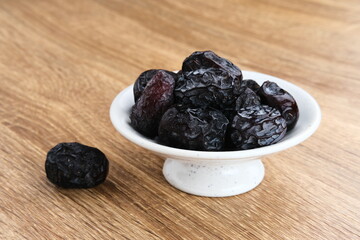 Kurma Ajwa, Ajwa Dates, served in small plate. Kurma Ajwa is one of the special fruit of Arabic.