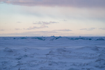 Blue Ice Chunks on Lake Michigan - Frozen Lake with snow, beautiful colorful sky, and clouds in the background