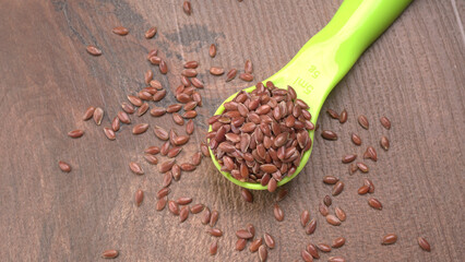 Brown flax seed or linseed on wooden background. Diet healthcare healthy food.
