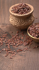 Brown flax seed or linseed on wooden background. Diet healthcare healthy food.
