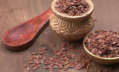 Brown flax seed or linseed on wooden background. Diet healthcare healthy food.
