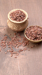 Brown flax seed or linseed on wooden background. Diet healthcare healthy food.
