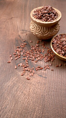 Brown flax seed or linseed on wooden background. Diet healthcare healthy food.
