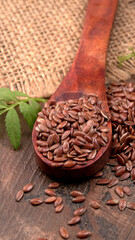 Brown flax seed or linseed on wooden background. Diet healthcare healthy food.