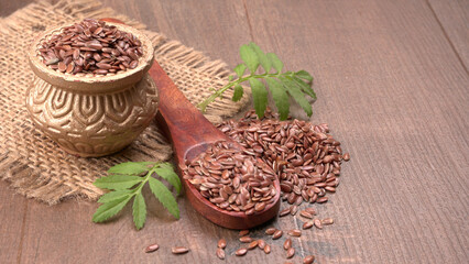 Brown flax seed or linseed on wooden background. Diet healthcare healthy food.