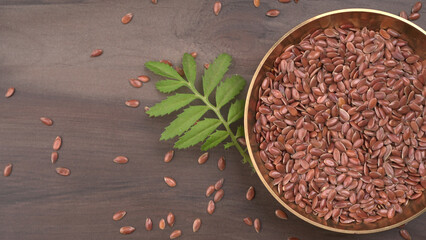 Brown flax seed or linseed on wooden background. Diet healthcare healthy food.