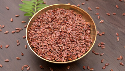 Brown flax seed or linseed on wooden background. Diet healthcare healthy food.