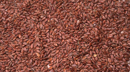 Brown flax seed or linseed on wooden background. Diet healthcare healthy food.