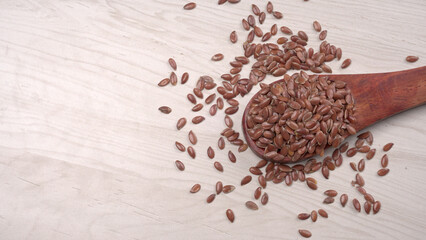 Brown flax seed or linseed on wooden background. Diet healthcare healthy food.