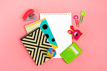 tationary, back to school, summer time, creativity and education concept. Supplies - notepad, pencils, paper clips, note, stapler on pink background, flatlay Mock up Top view