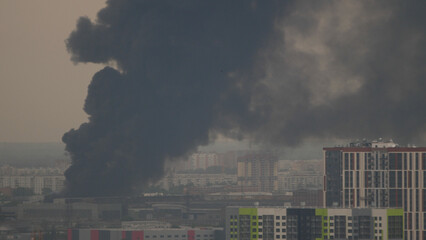 Black smoke from the fire of a new residential skyscraper in the city.