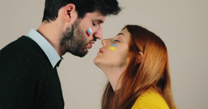Couple with Russian and Ukraine flag are kissing, concept of peace and stop war