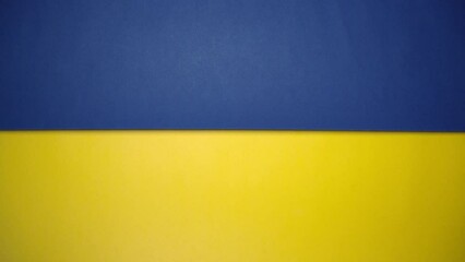 Blue and yellow paper rolling on green screen. Blue and yellow are colors of Ukraine national flag.
