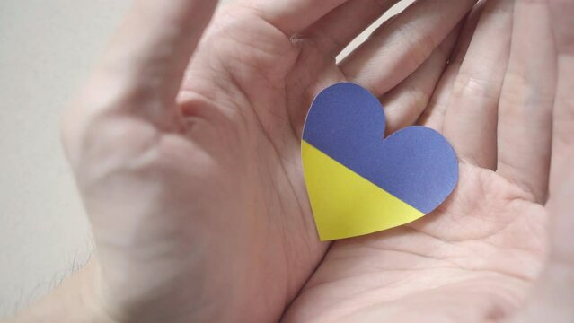 Ukraine flag color heart in hands