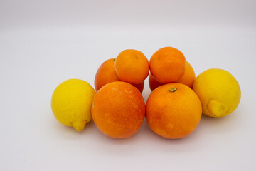 Few oranges, tangerines and lemons on white background.