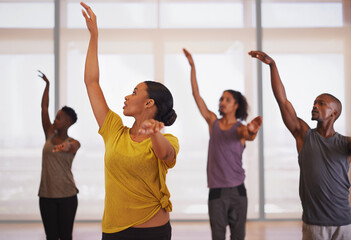 Friends and dance partners. Shot of a group of people practicing in a dance studio.