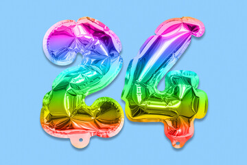 Rainbow foil balloon number, digit twenty four on a blue background. Birthday greeting card with inscription 24. Top view. Numerical digit. Celebration event, template.