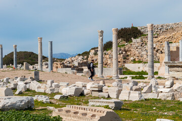 Knidos was a Greek city in ancient Caria, located by sea in Datca, Mugla, Turkey.  A tourist, traveler boy discovering places.
