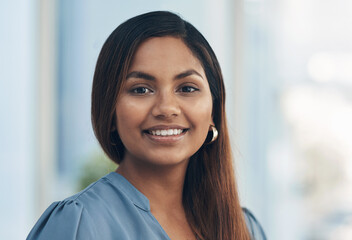 Success starts with attitude, so stay positive. Portrait of a confident young businesswoman in an...